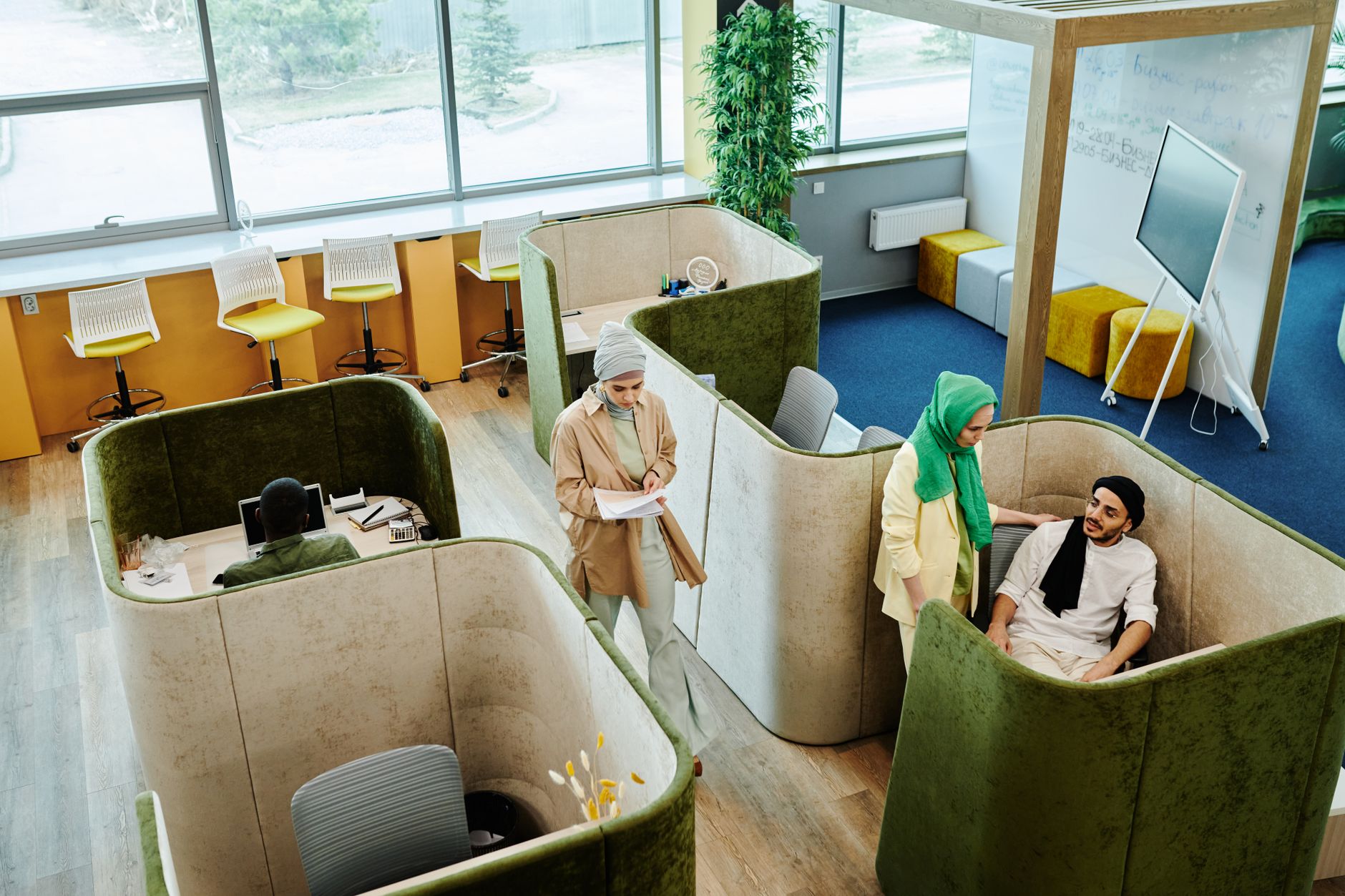 Modern office environment with diverse team collaborating in pod-style workspaces. — Boxing streams Provide Free Access to Ma