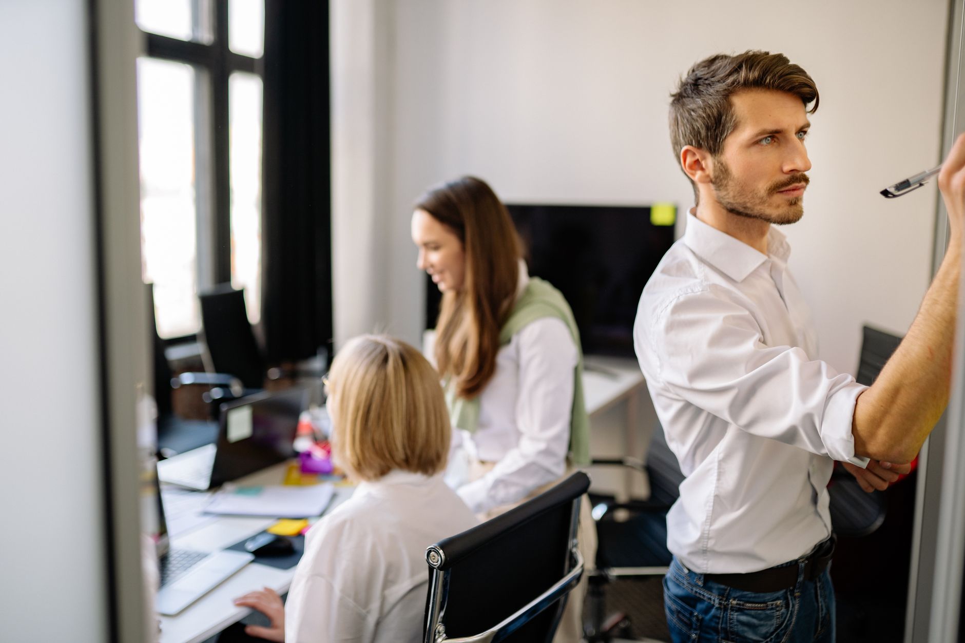 A focused team working together in a modern office setting, brainstorming and collaborating. — Kaleidescape Price: Everything