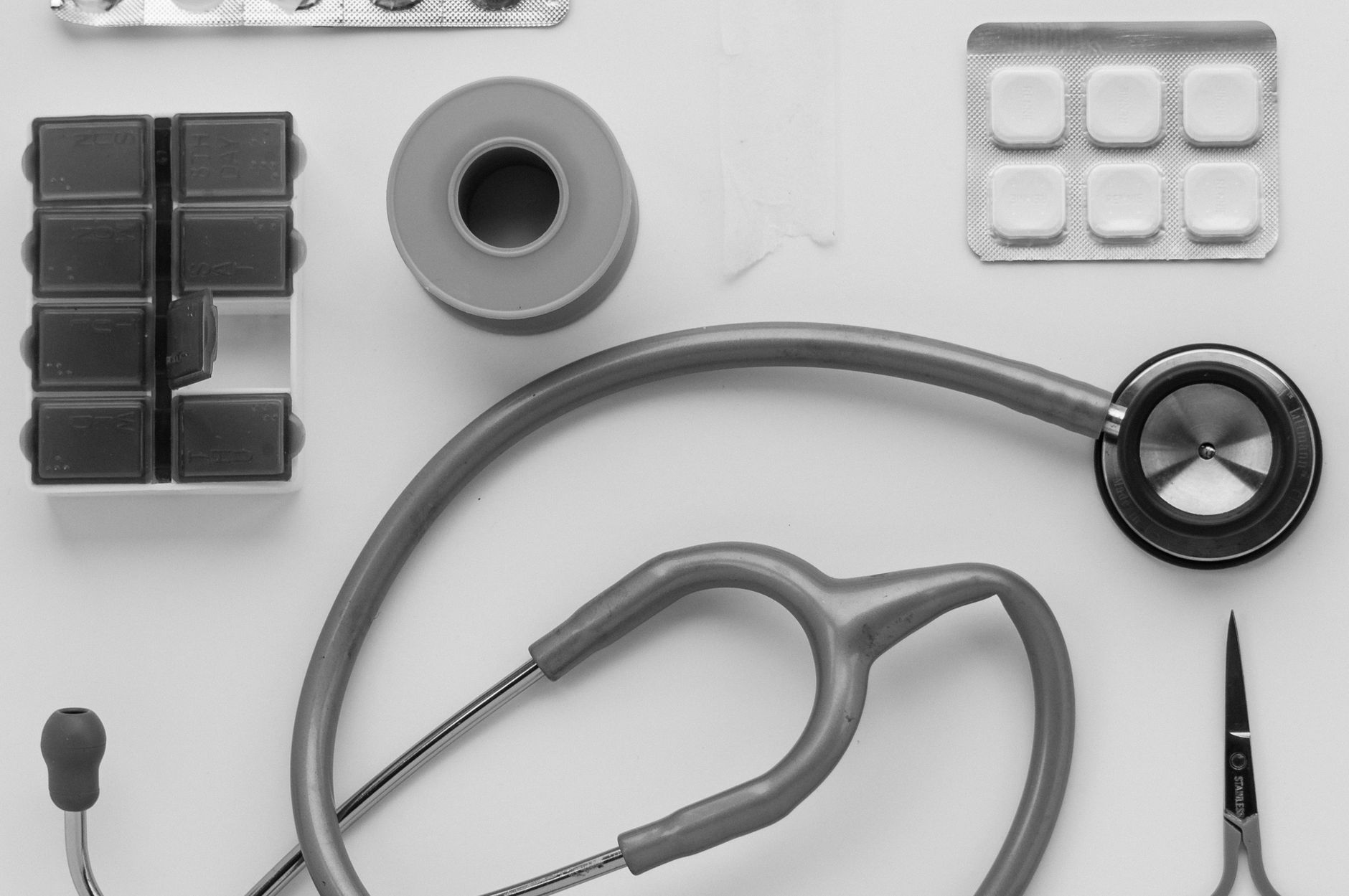 Top view of medical instruments and pills arranged on a white background. — Pharmaqo Labs Explained: What Makes Their Product