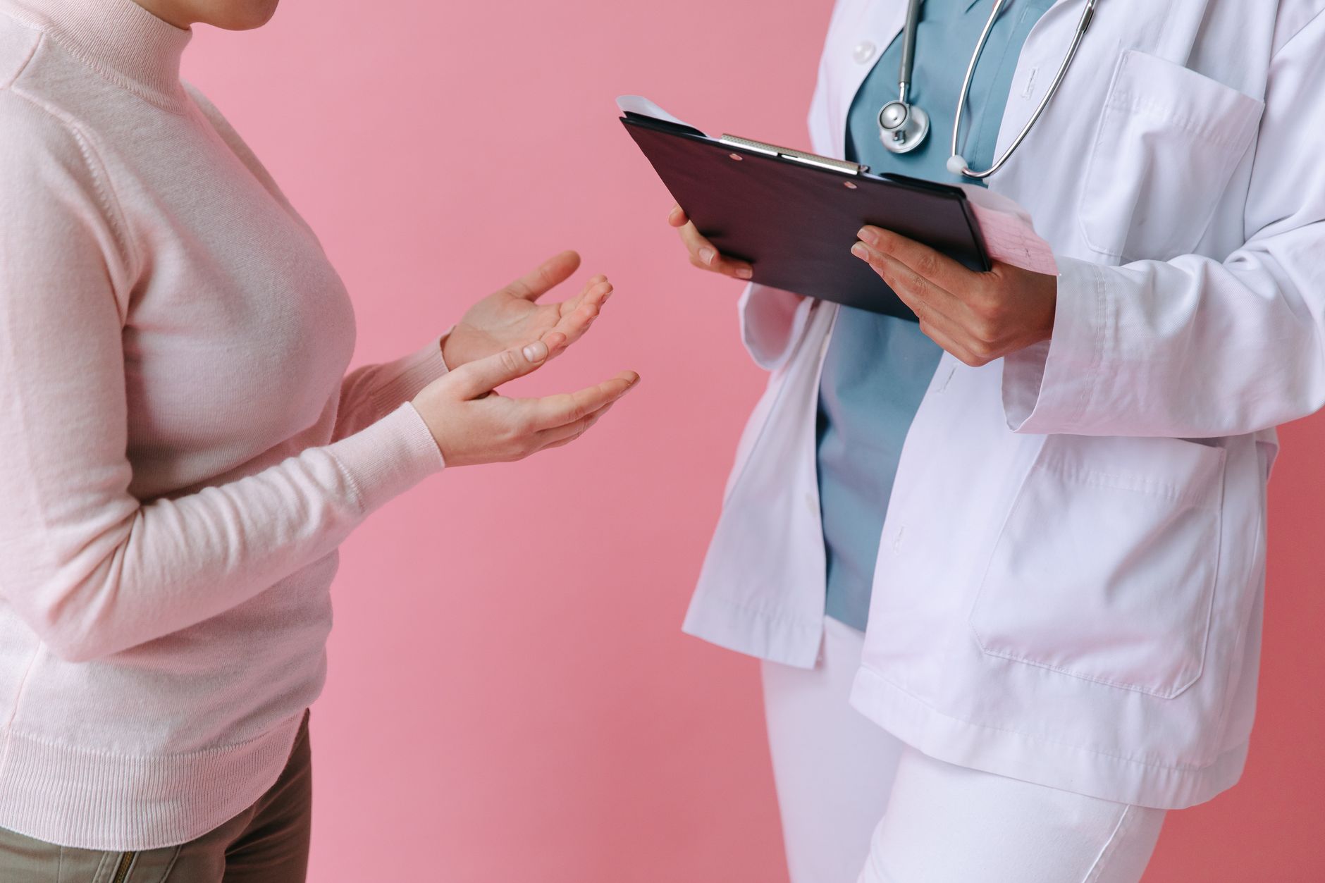 Close-up of a patient consulting a doctor with a clipboard in a medical setting. — UNT HSC Fort Worth: A Guide to Admissions